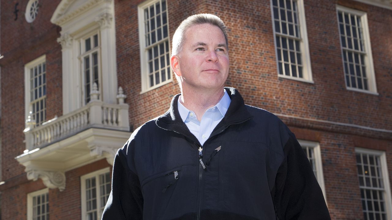 Mike Sullivan joins Acquia A man in a black jacket stands outside a brick building, looking into the distance.
