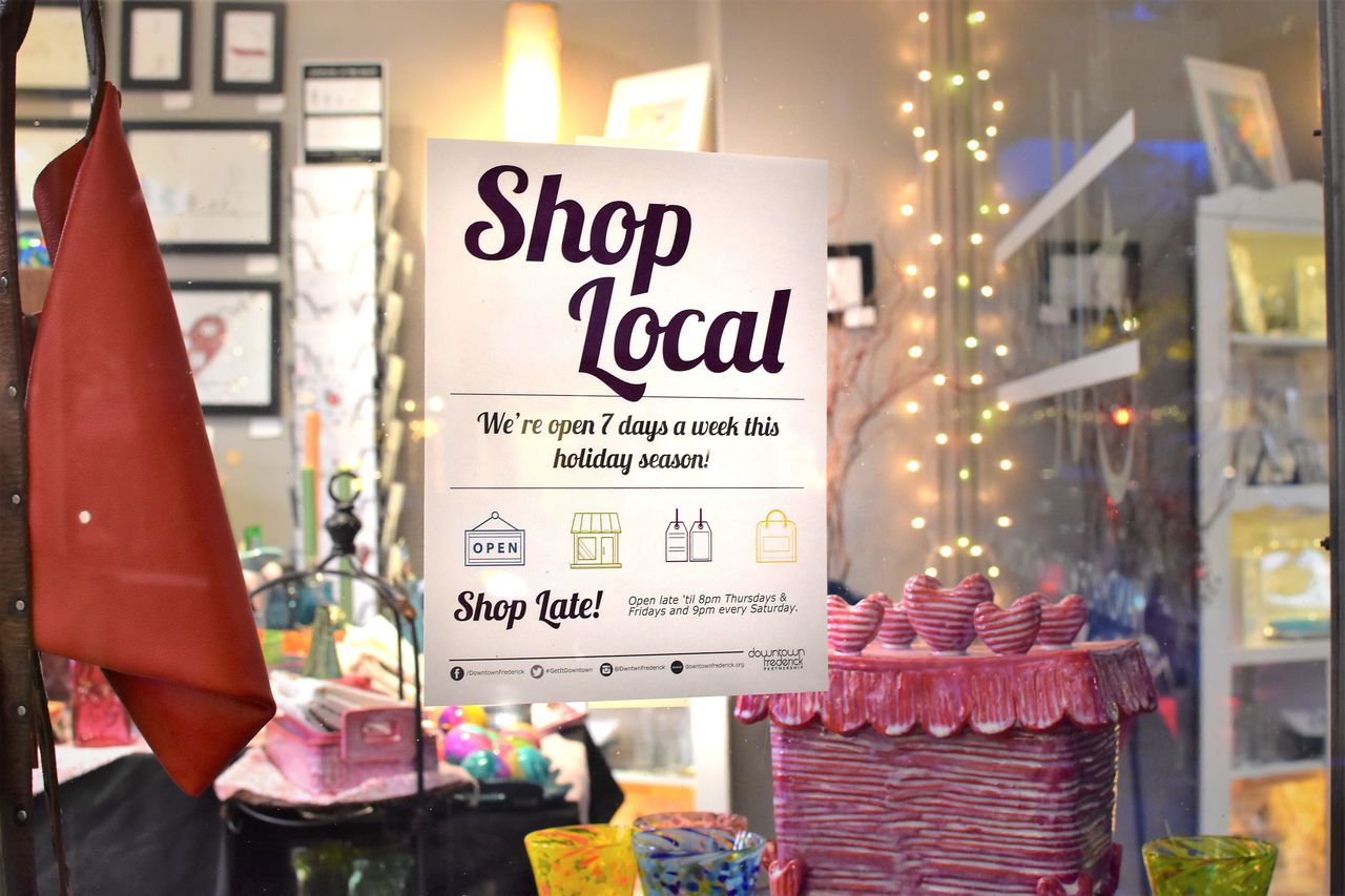 Shop local A window of a shop with a 'shop local' sign.