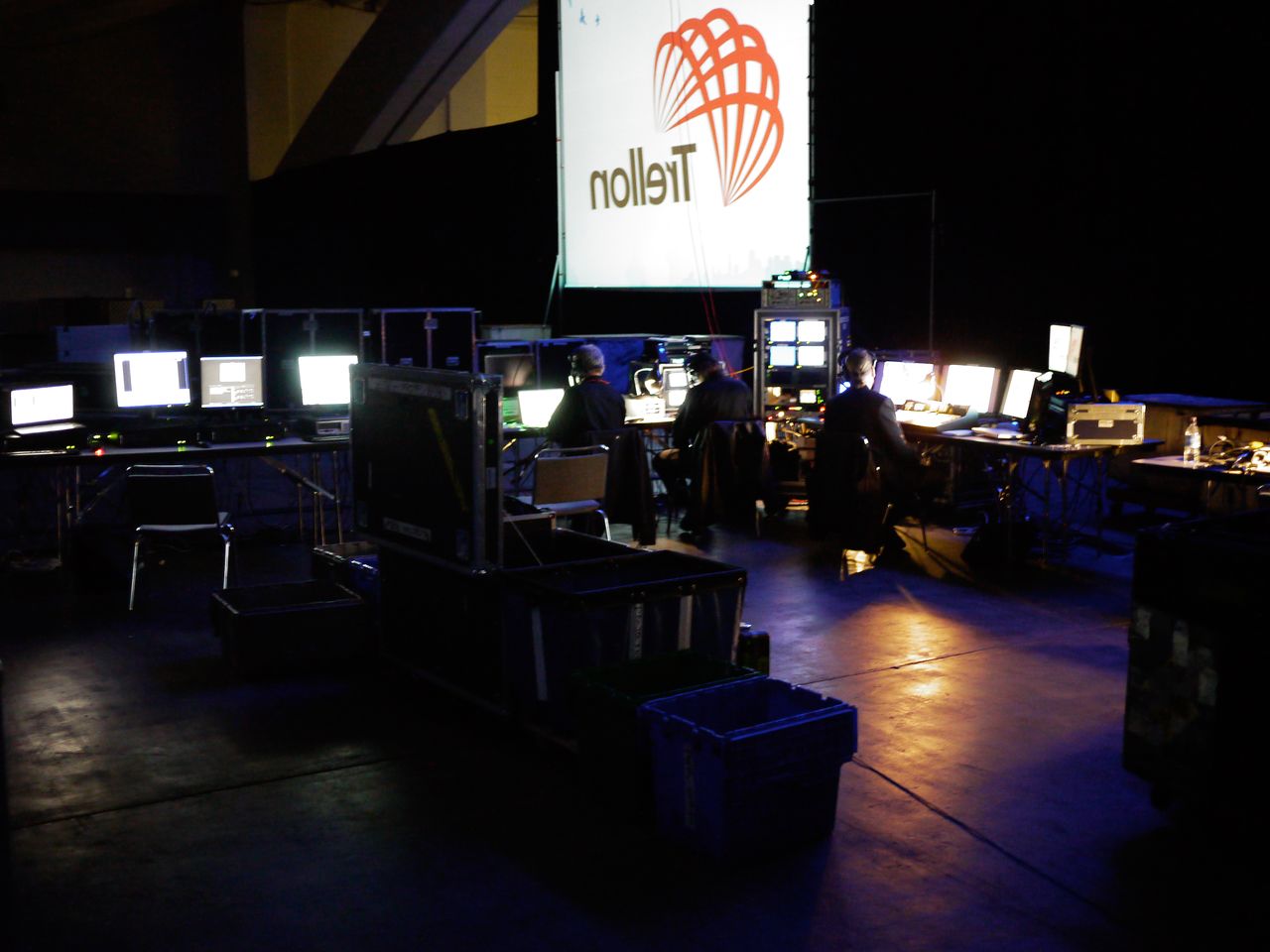 Keynote backstage People working at computer stations backstage, managing technical equipment and screens before a keynote presentation at DrupalCon 2010.