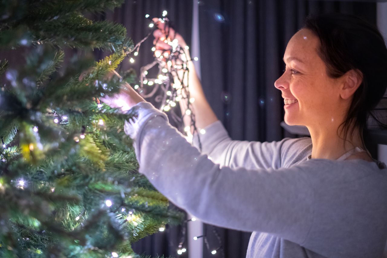 Christmas tree lights Vanessa hanging the lights in the Christmas tree