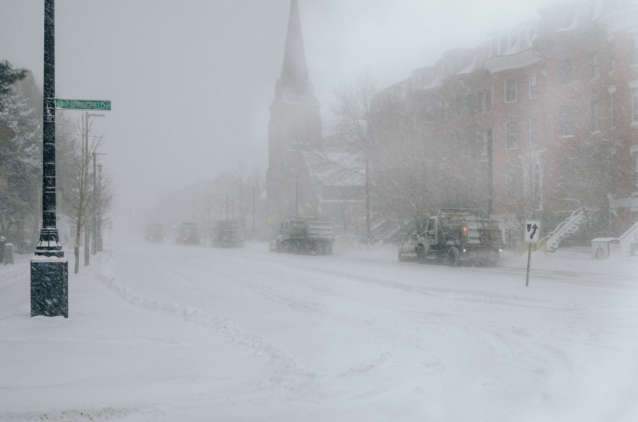 Phalanx of snow plows Five snow plows driving behind each other during a Boston snowstorm.